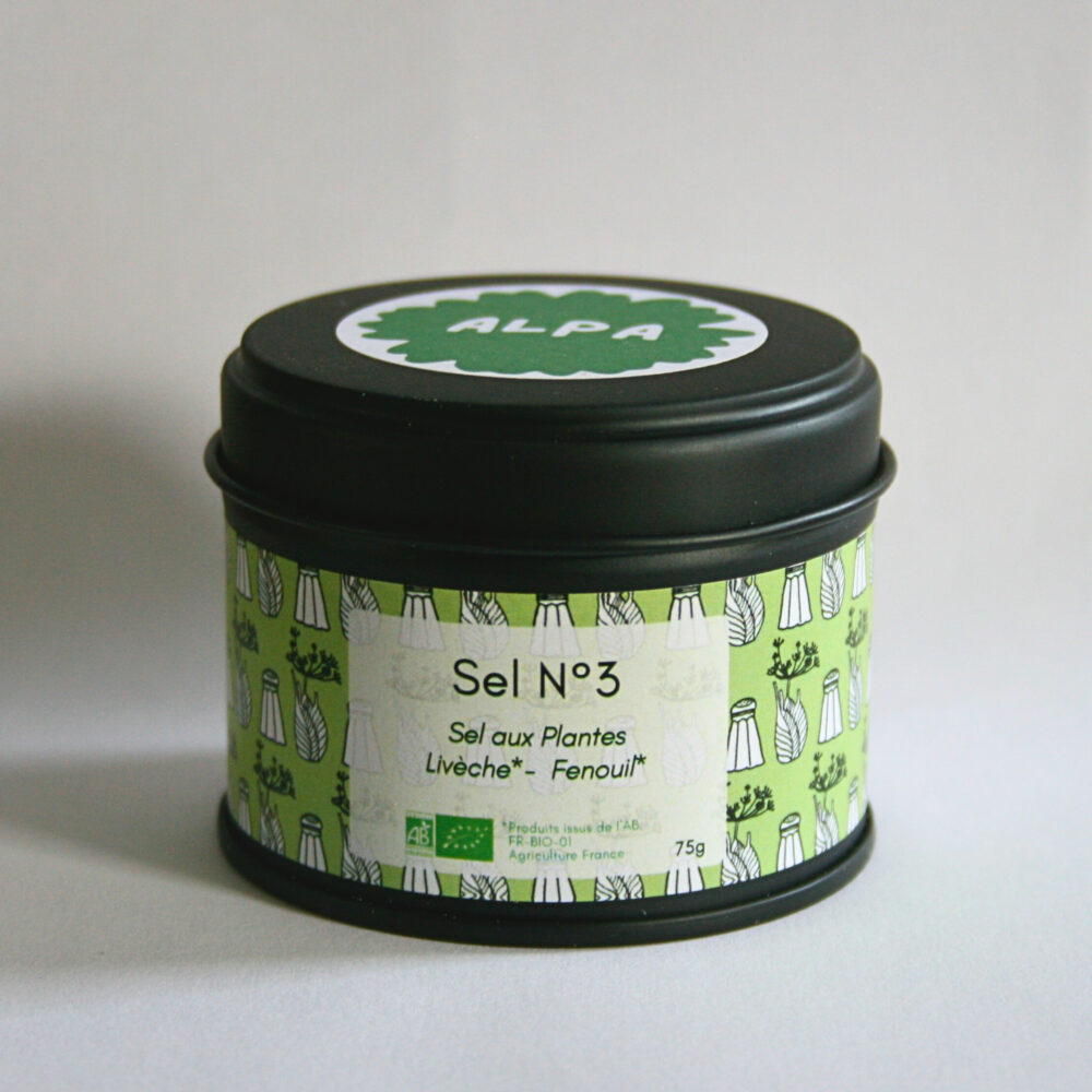 Pot en métal noir fermé contenant le sel aromatique à la livèche et au fenouil, posé sur un fond blanc épuré.